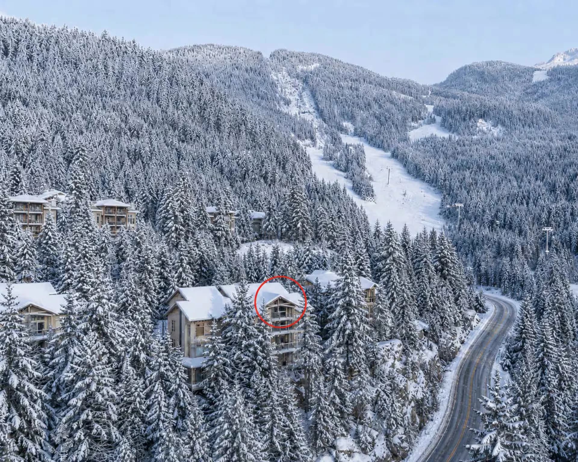 Aerial view of a luxury ski chalet in snow